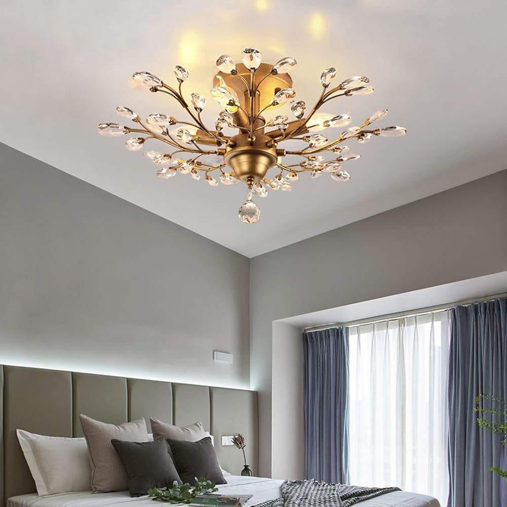 Crystal branch chandelier with gold finish in modern bedroom.