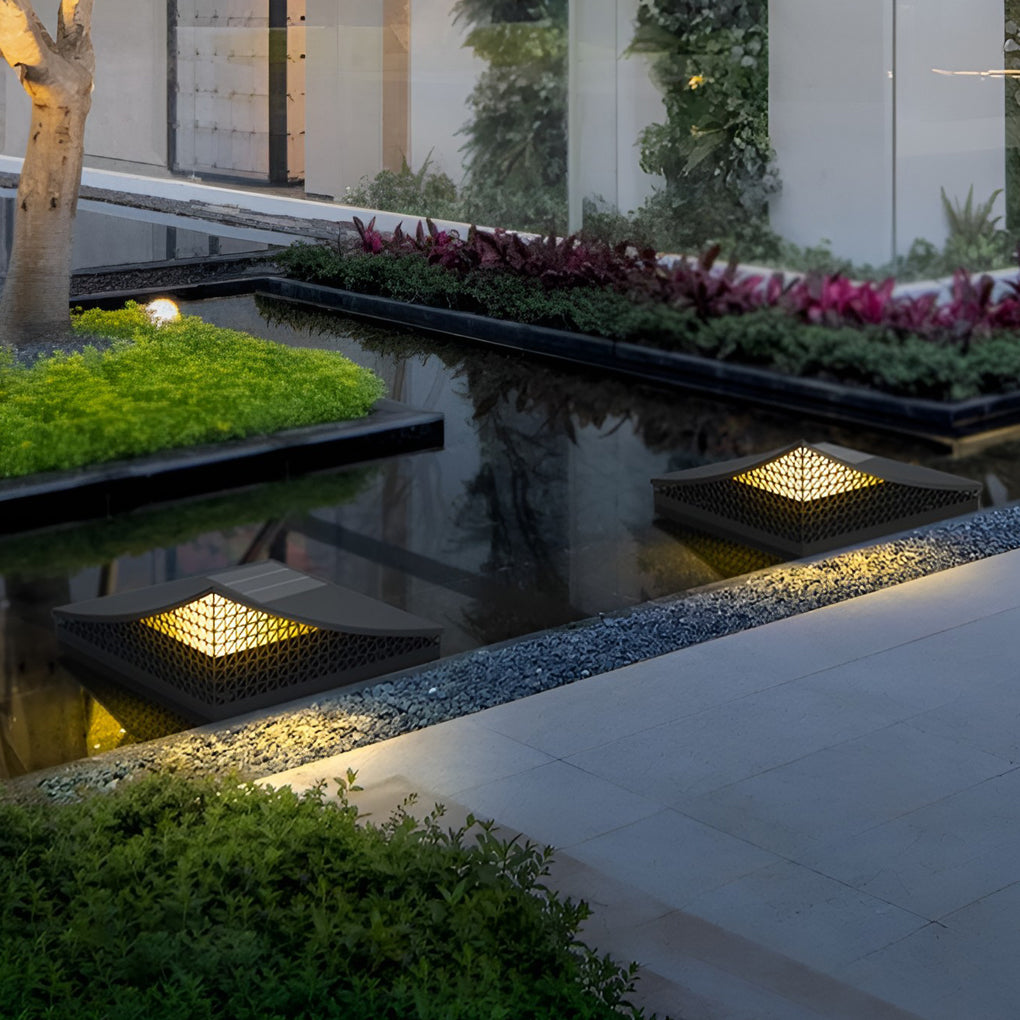 Curved landscape light displayed on a stone pillar with a reflective surface.