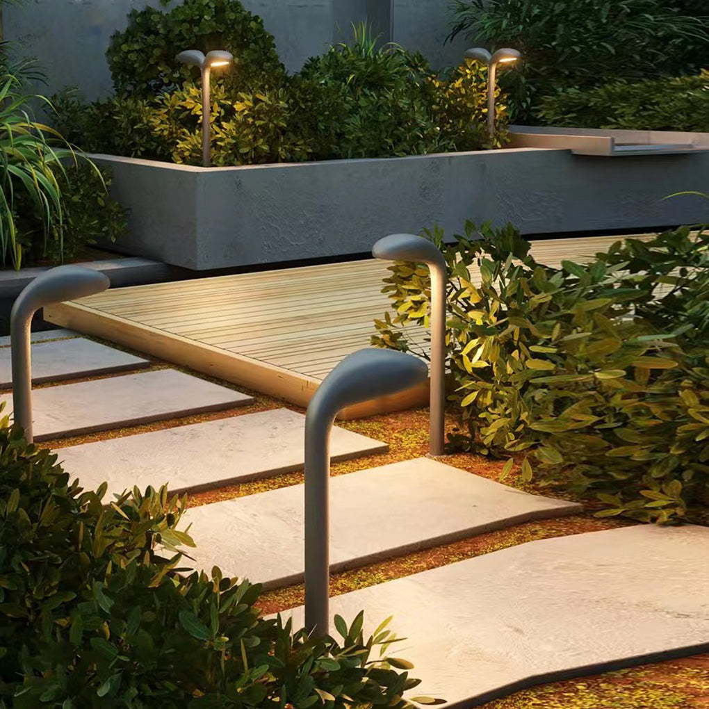 Curved path light providing elegant illumination for a contemporary landscape.