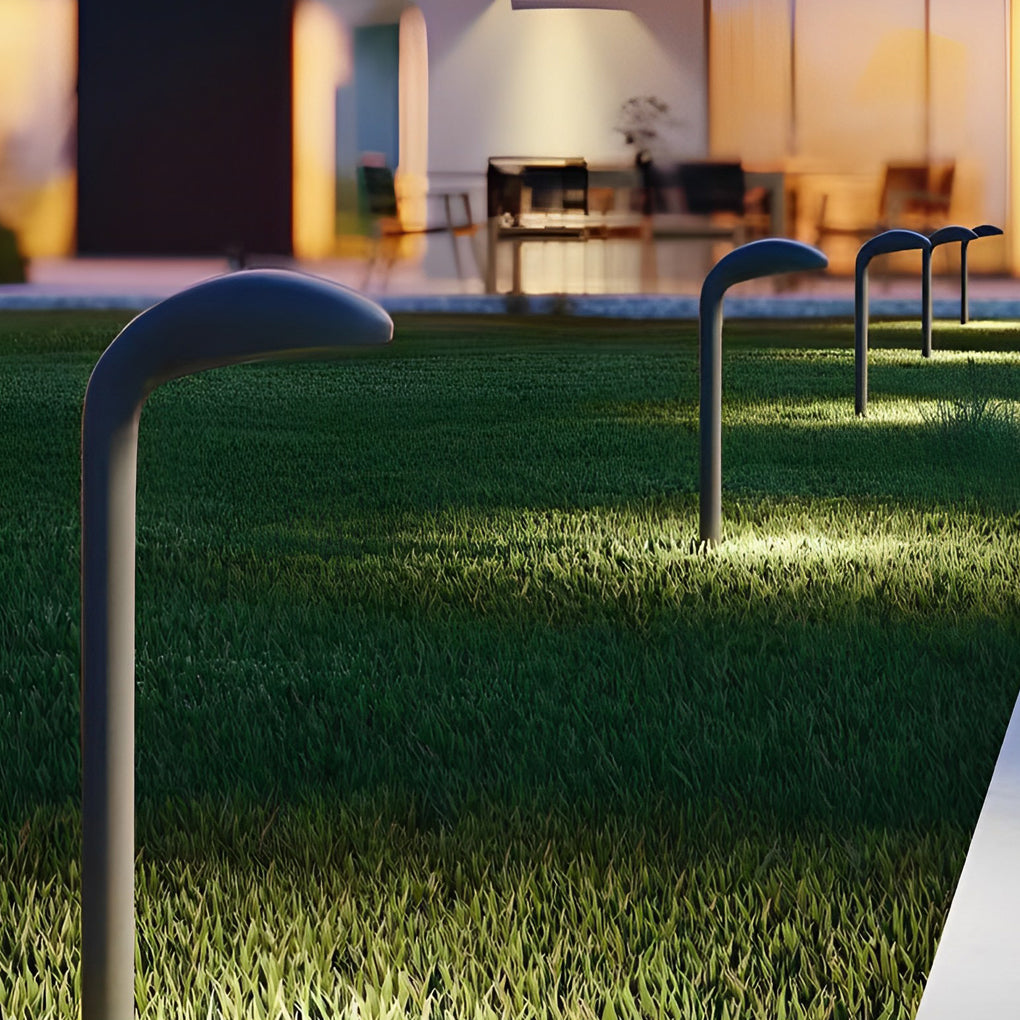 Curved path light enhancing a stylish outdoor entrance with ambient light.