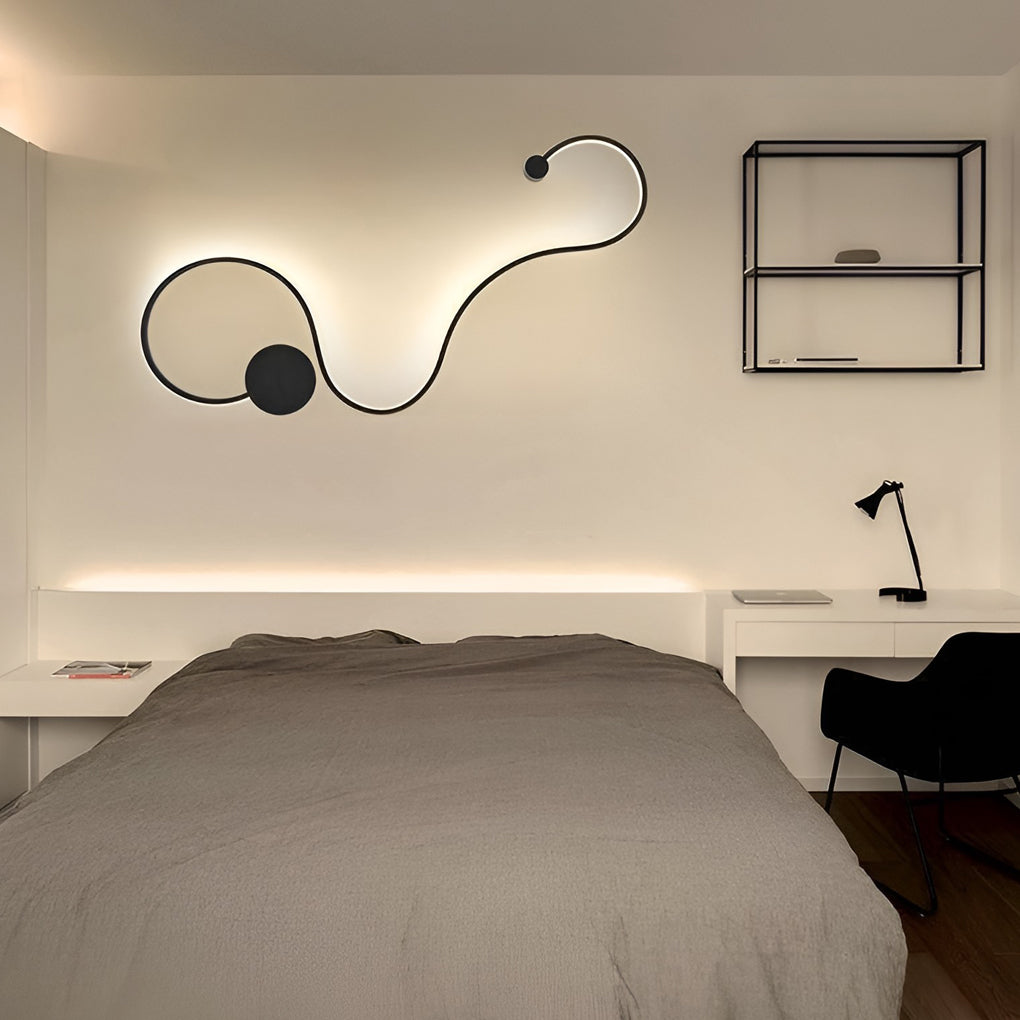 Curved wall sconce providing warm ambient lighting in a contemporary bedroom.