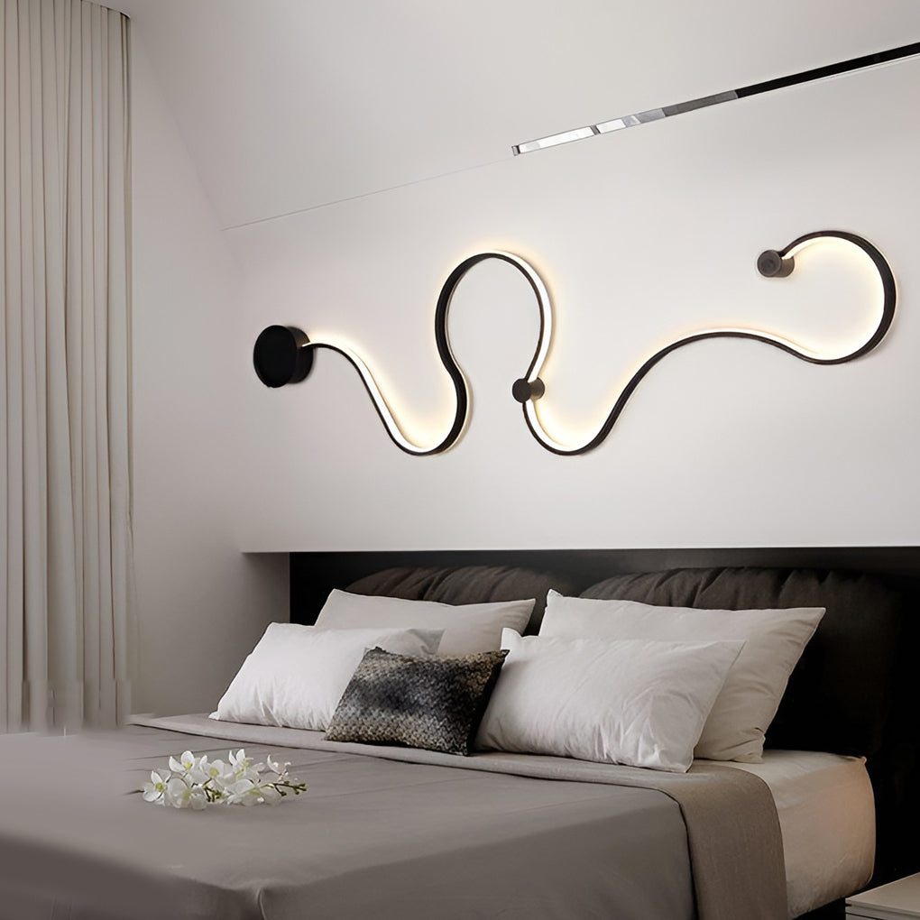 Curved wall sconce used as bedside accent lighting in a modern bedroom.