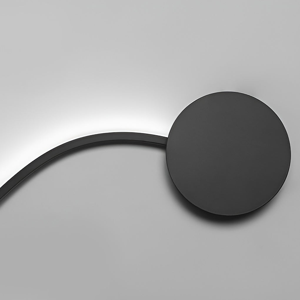 Close-up view of a curved wall sconce with matte black finish and LED light.