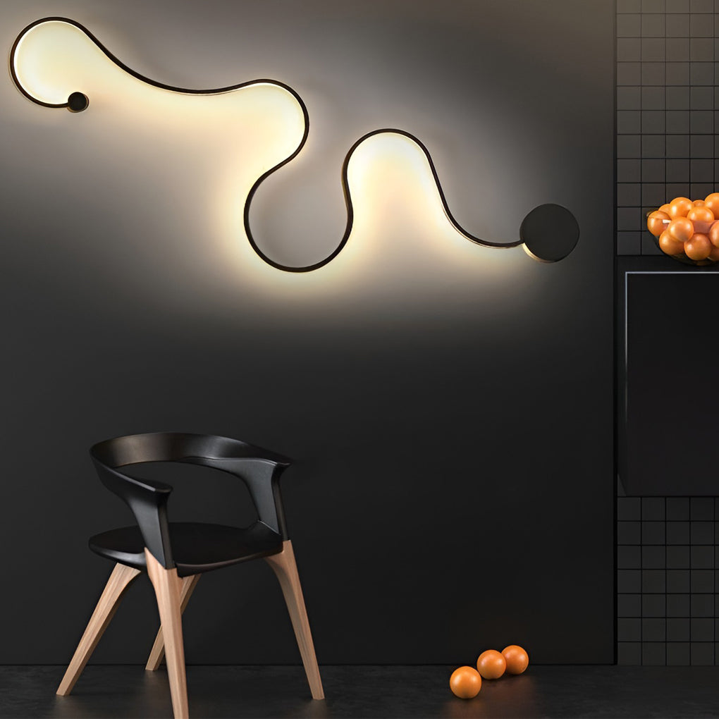 Curved wall sconce creating a warm glow against a dark interior wall.