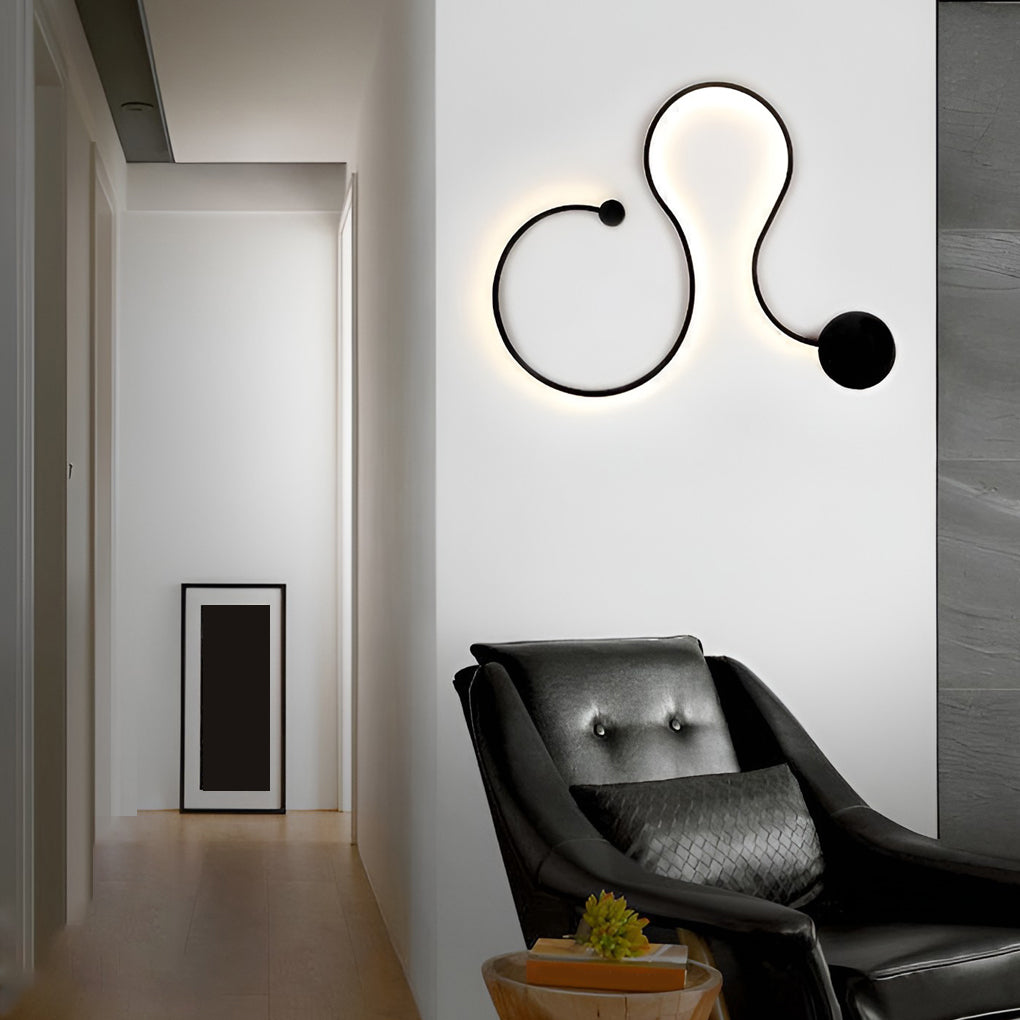 Artistic curved wall sconce used as accent lighting in a modern hallway.