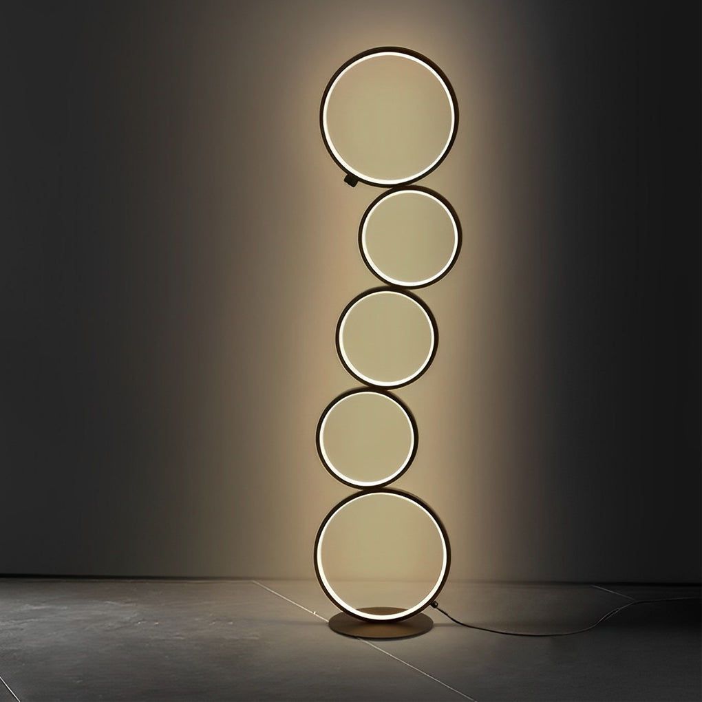 Decorative floor lamps with circular design, providing focused light in a minimalist interior setting.