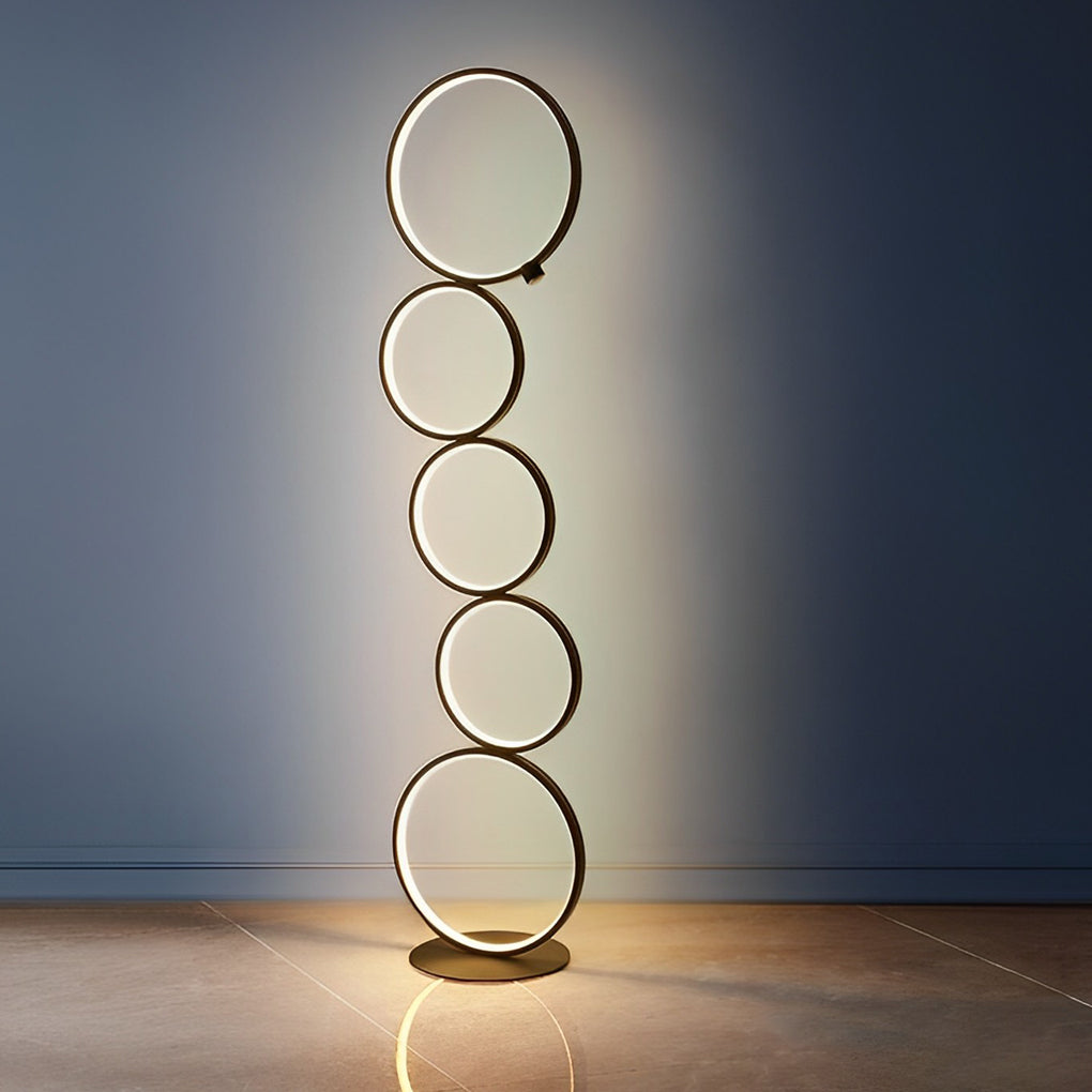 Decorative floor lamps with circular LED rings, displayed against a dark background for a striking contrast.
