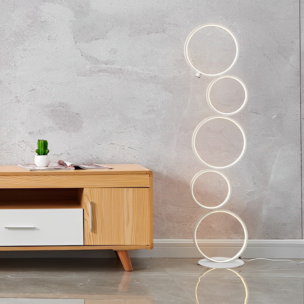 Decorative floor lamps with minimalist circular design, standing in a bright and modern living area.