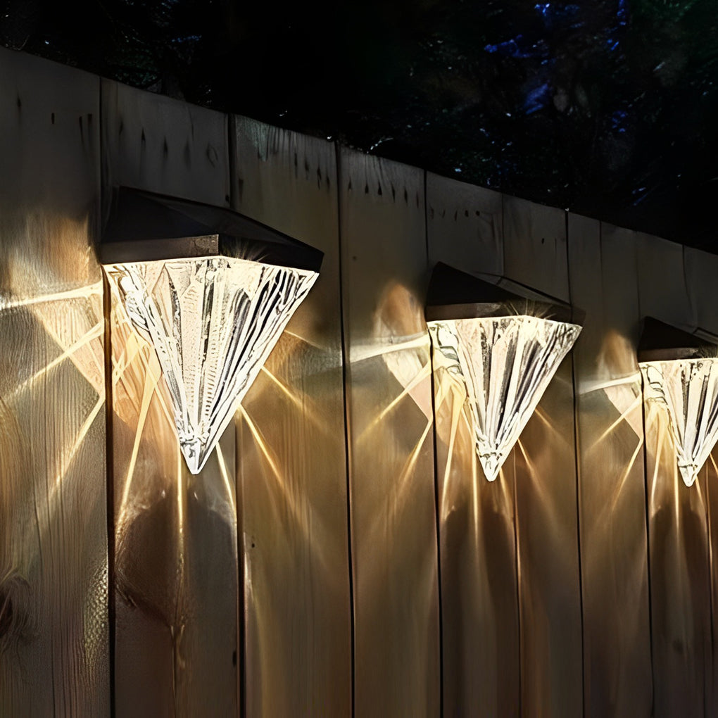 Diamond wall lights providing soft illumination along a stylish outdoor pathway.