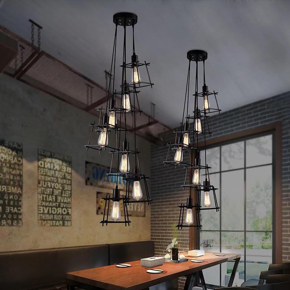 Dining table lighting design using multiple hanging cage pendant light fixtures with vintage bulbs.