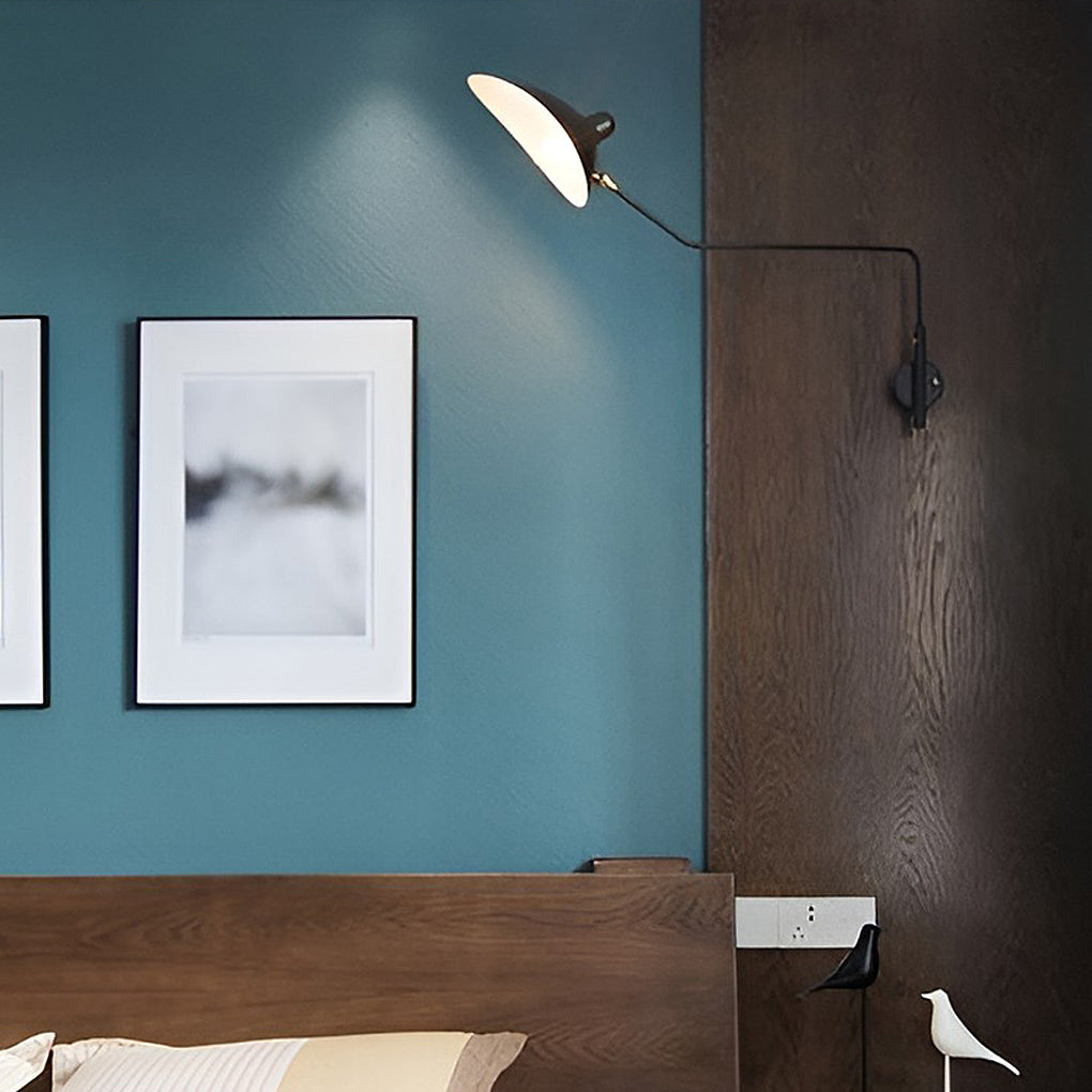 Double arm wall sconce mounted on a teal wall, adding contrast and functional lighting to a minimalist bedroom.