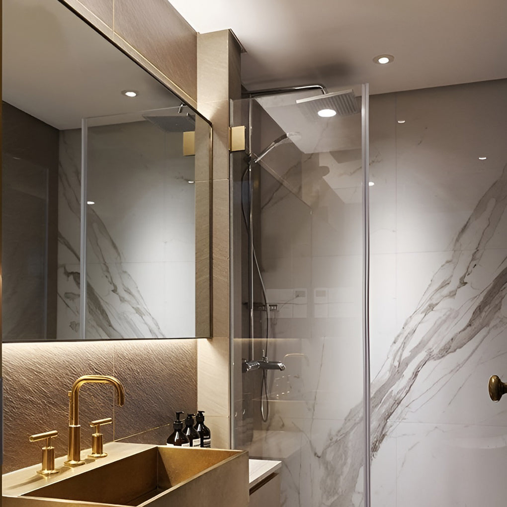 Luxury bathroom space enhanced by neutral white elite lighting can lights in ceiling layout.