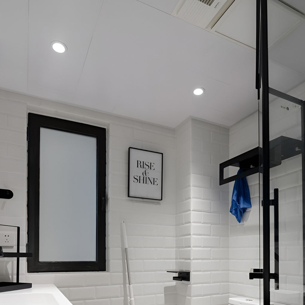Minimalist bathroom design using elite lighting can lights for balanced overhead illumination.