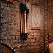 Vintage industrial wall sconce with exposed Edison bulb, mounted on rustic brick wall for warm ambient lighting.
