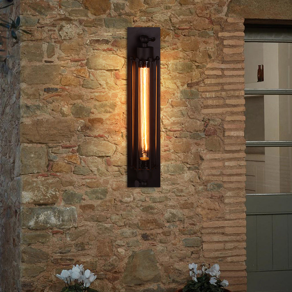 Vintage industrial wall sconce with exposed bulb, installed on rustic brick wall beside wooden door.