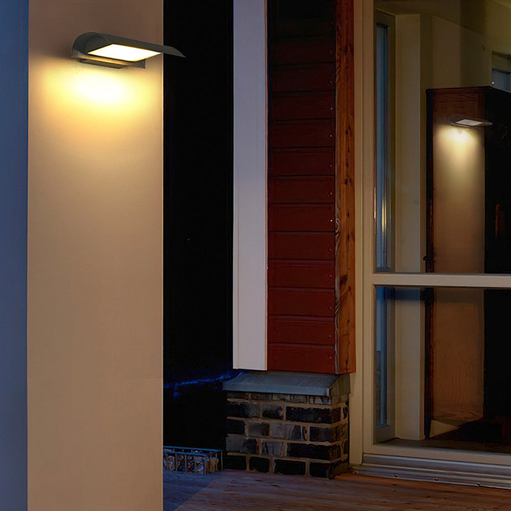 Minimalist exterior down wall lights installed beside front door creating warm entryway lighting.
