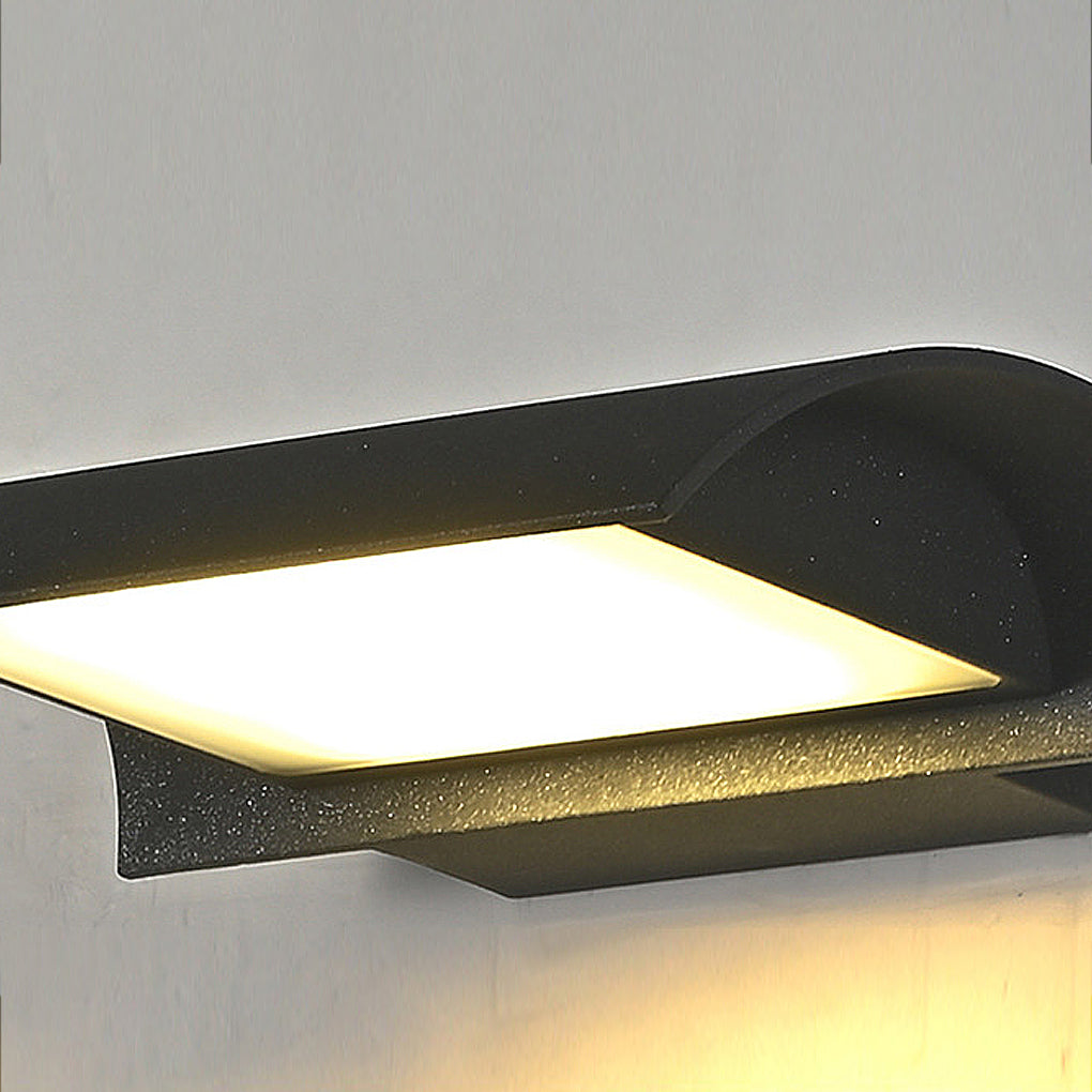 Close-up detail of exterior down wall lights showing curved metal housing and LED panel.