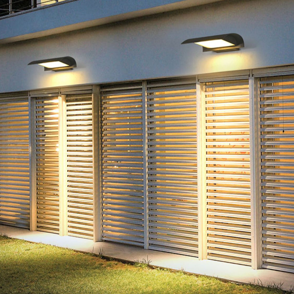 Exterior down wall lights illuminating exterior wall with horizontal slatted facade at night.