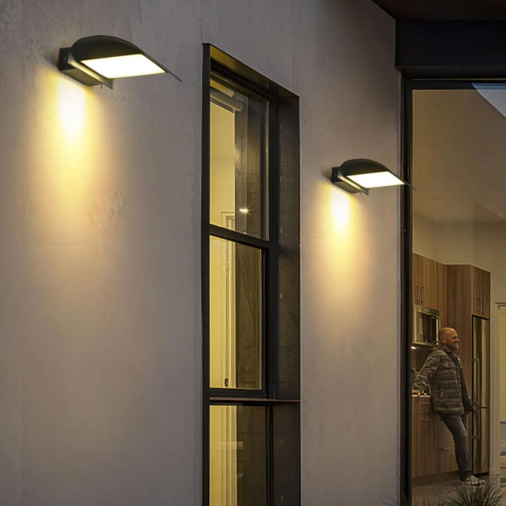 Exterior down wall lights mounted beside tall window creating vertical architectural lighting effect.