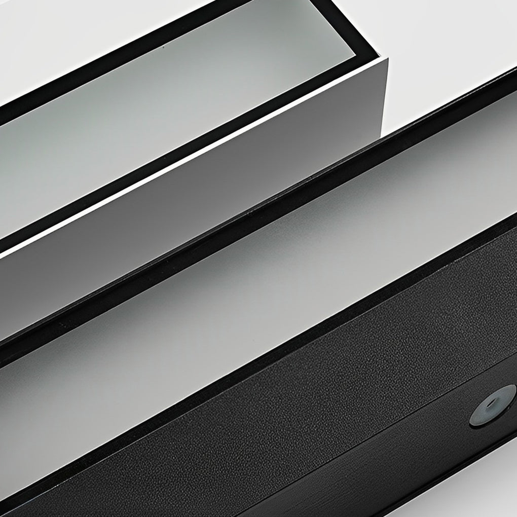 Close-up detail of exterior porch light fixtures showing slim metal housing and LED diffuser.