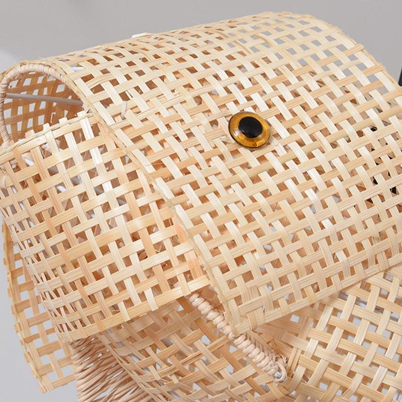 Fish pendant light with a woven design, illuminating a modern interior.