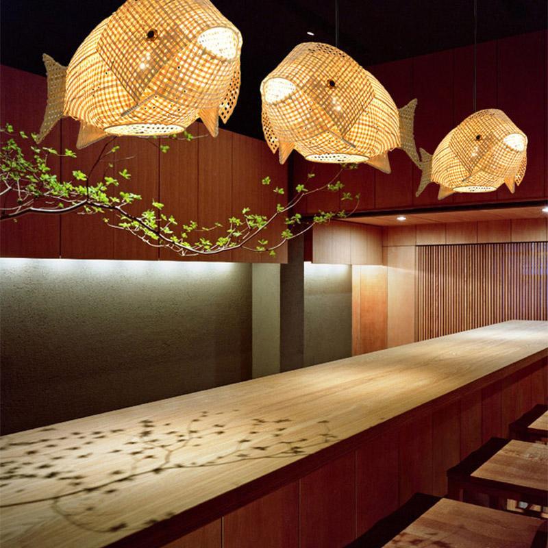 Fish pendant light with a woven design, providing warm illumination in a stylish dining room.