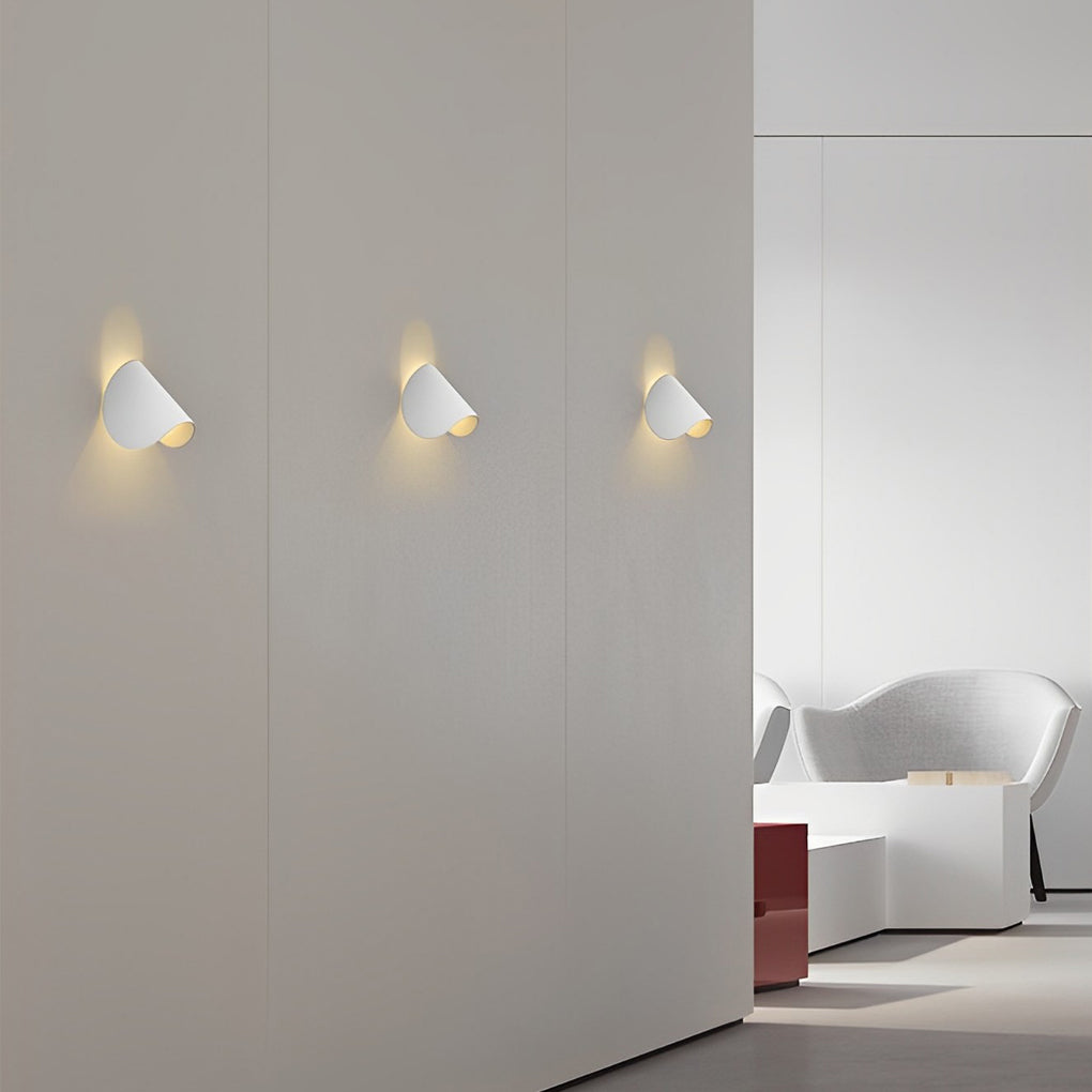 Folding wall sconce illuminating a cozy reading nook with ambient light.