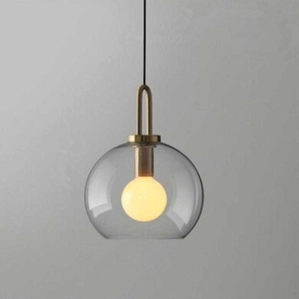 Frosted glass mini pendant lights with a close-up of the glass shade and gold frame.