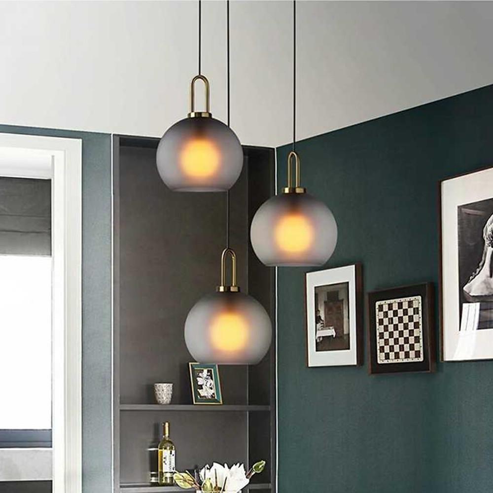 Frosted glass mini pendant lights enhancing a stylish bedroom corner with sleek, minimalist design.