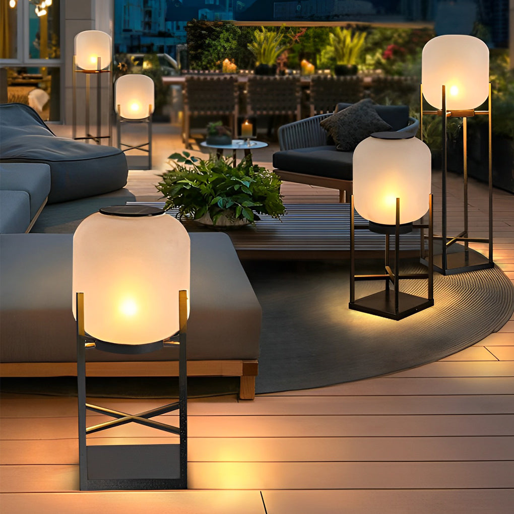 Outdoor standing light with frosted glass shade on wooden deck with scenic evening view.