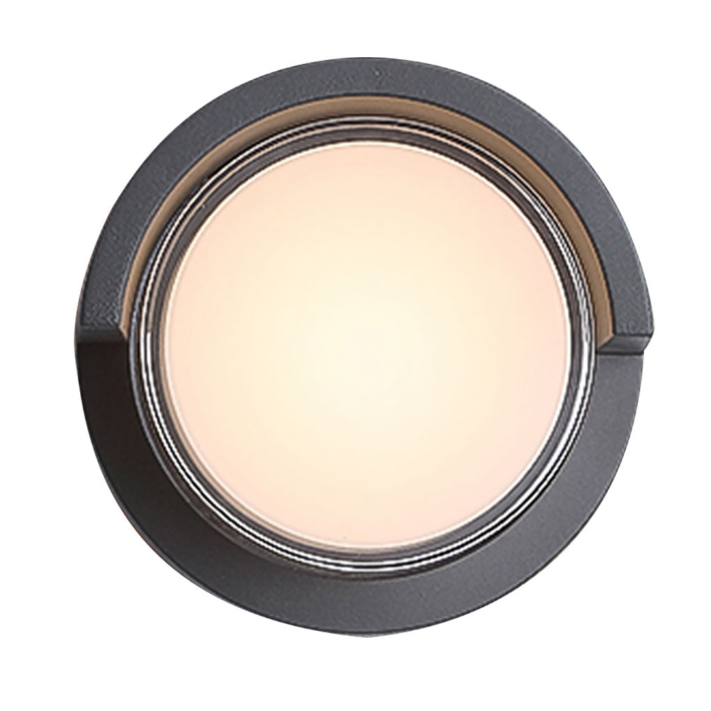 Geometric outdoor sconce with close-up of its circular design and light.