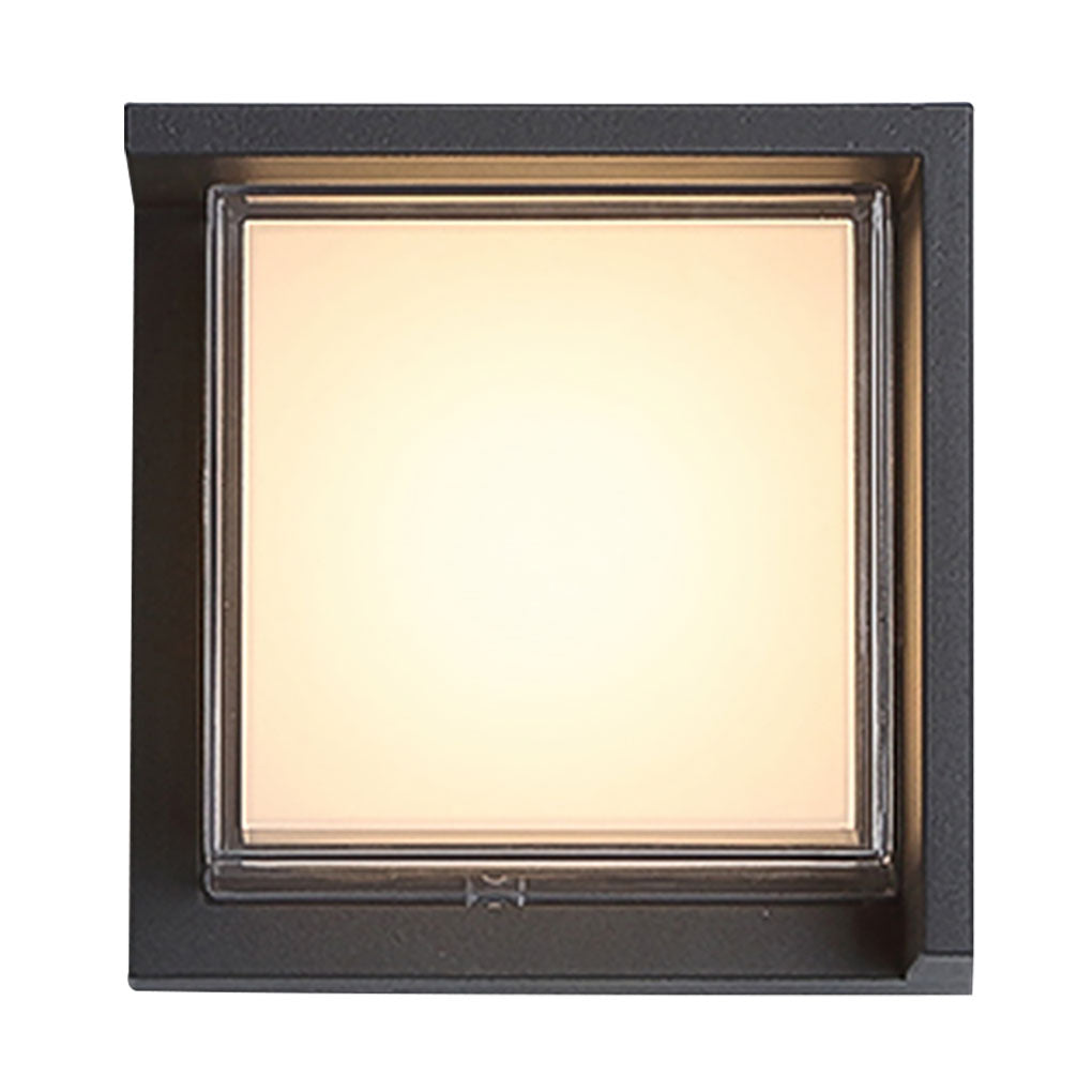 Geometric outdoor sconce illuminating a contemporary building with soft glow.