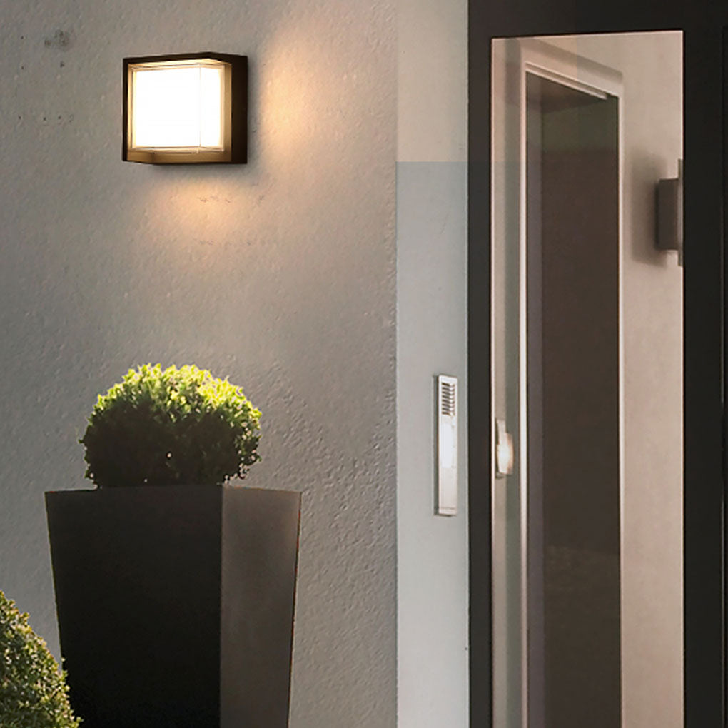 Geometric outdoor sconce enhancing a modern house entrance with warm light.