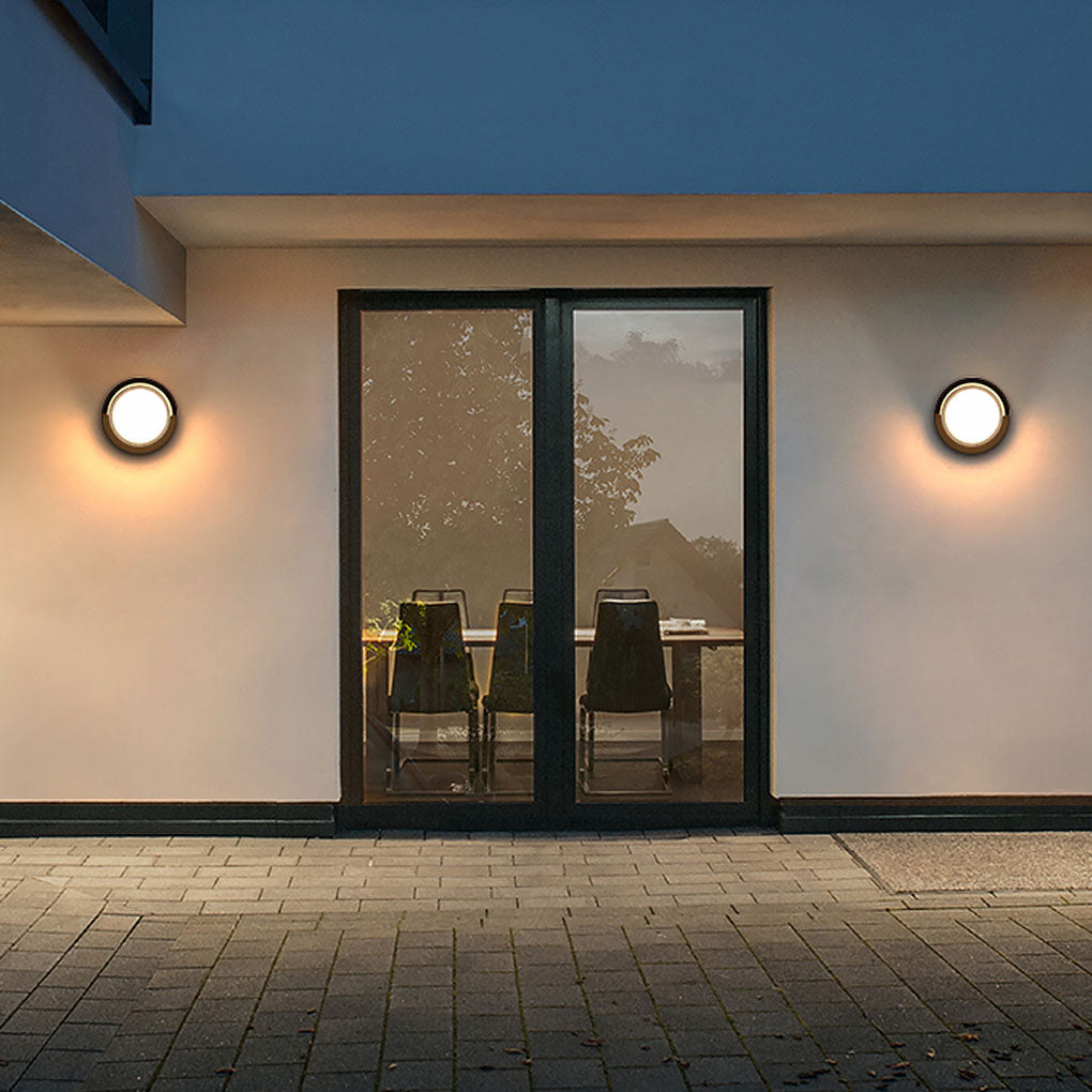 Geometric outdoor sconce illuminating a stylish building facade with elegant glow.