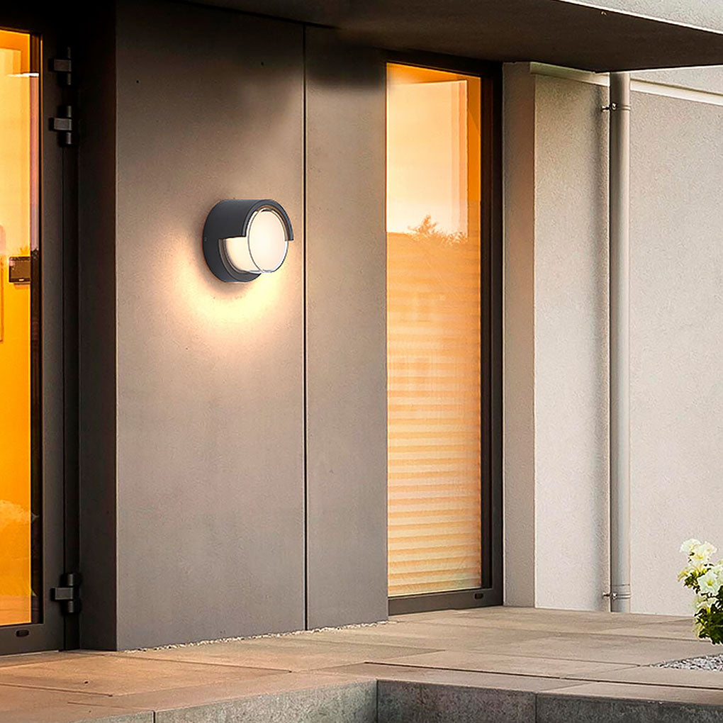 Geometric outdoor sconce providing elegant illumination near a stylish door.