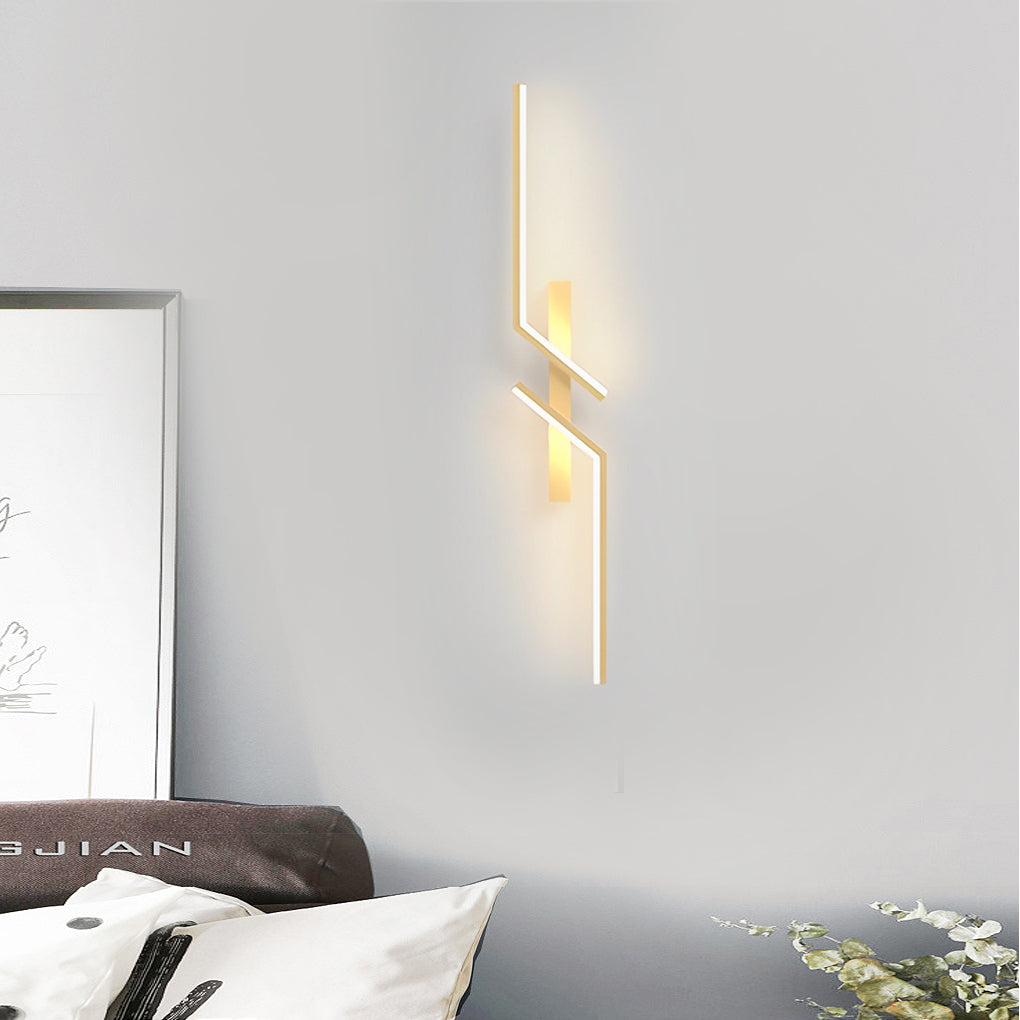 Geometric wall sconce in a contemporary bedroom, casting soft light on the wall.