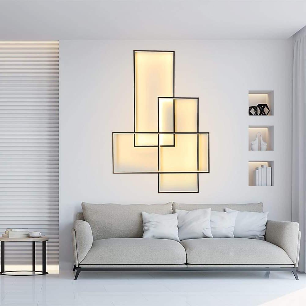 Geometric wall sconce casting a gentle glow in a minimalist living room.