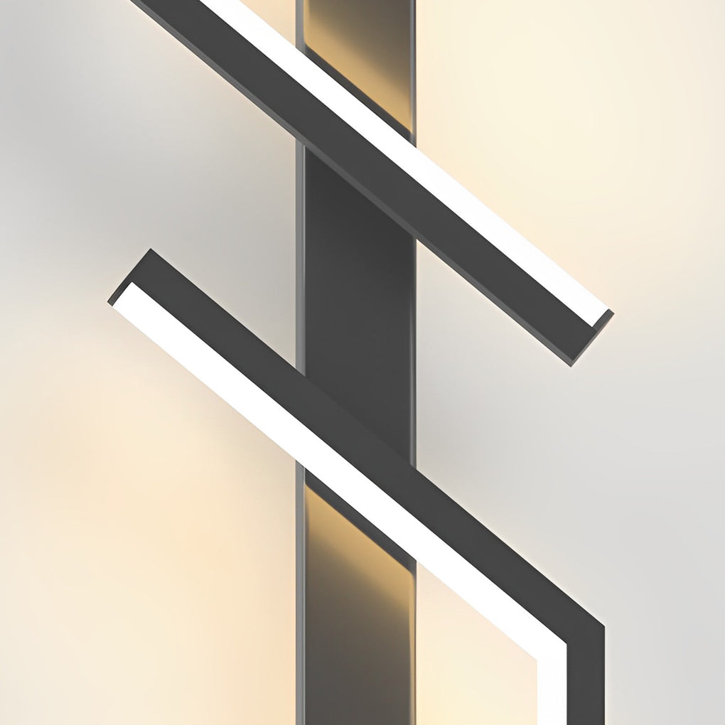 Geometric wall sconce with a gold finish, mounted on a wall in a contemporary space.