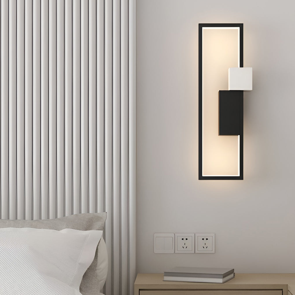 Geometric wall sconce light enhancing a modern dining area with warm light.