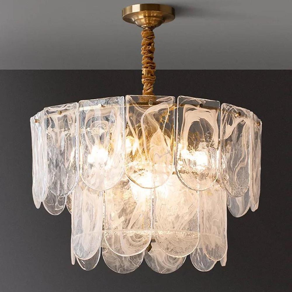 Close-up glass drum chandelier details showing textured crystal prisms, gold accents, and vintage bulbs.