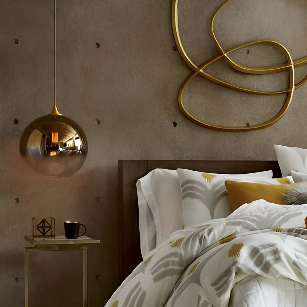 Glass round pendant light used as a bedside lighting solution.