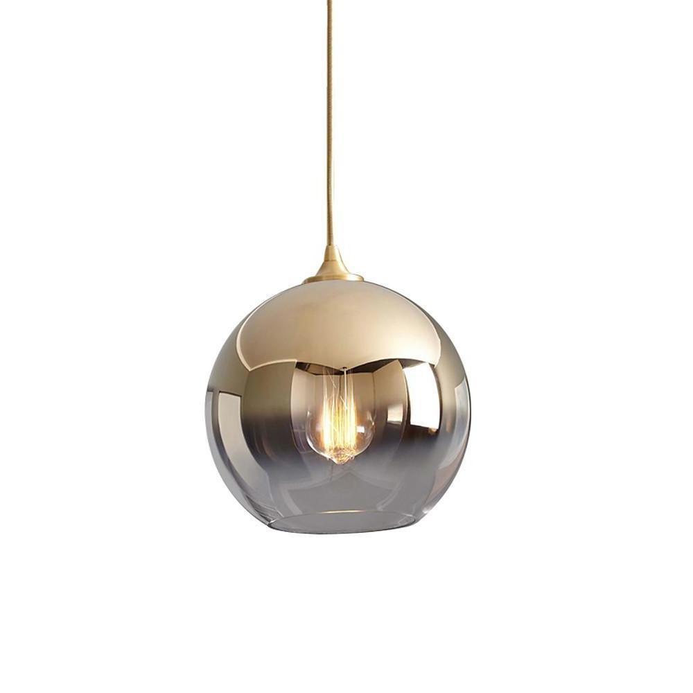 Glass round pendant light displayed against wall art decor.