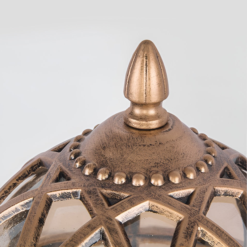 Globe pillar lights with bronze frame, top view of decorative finial and glass globe.