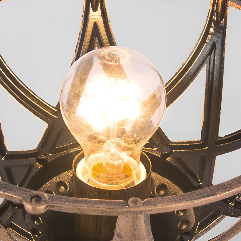 Globe pillar lights with bronze frame, close-up of illuminated glass and metalwork.