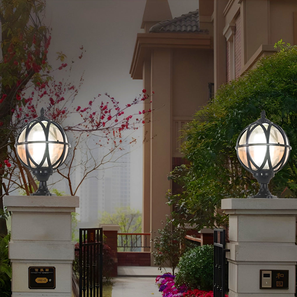 Globe pillar lights with classic design, casting warm light near wooden gate.