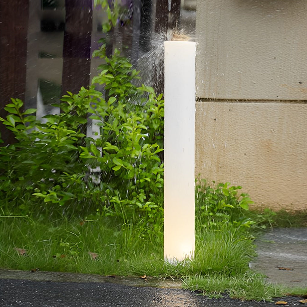 Glowing pillar light providing elegant illumination for a contemporary landscape.