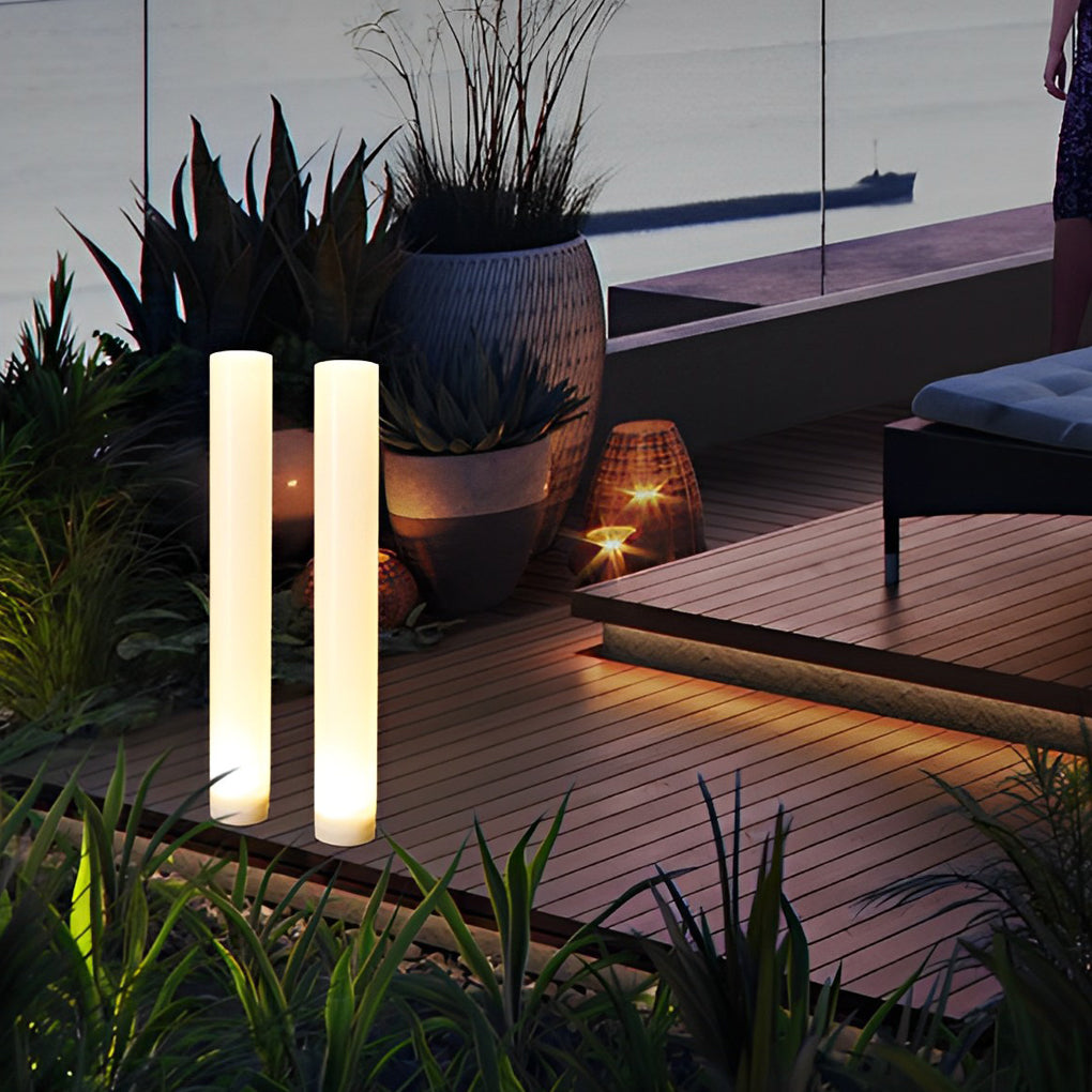 Glowing pillar light illuminating a cozy outdoor deck with directional glow.
