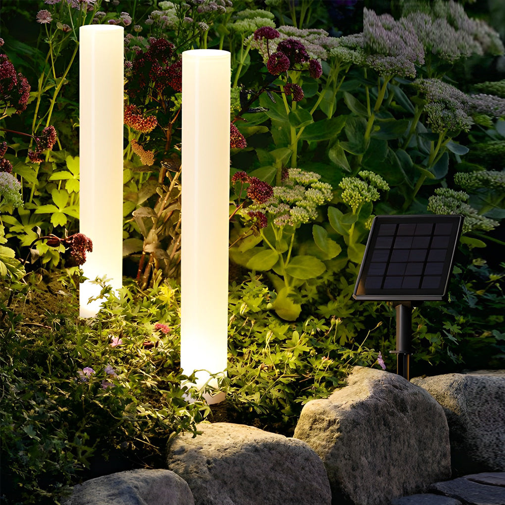 Glowing pillar light providing soft illumination along a stylish outdoor pathway.
