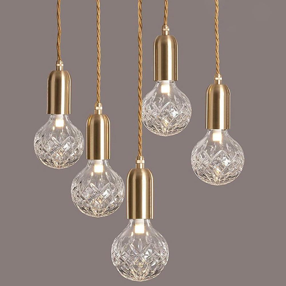 Gold acrylic bulb chandelier with clear textured bulbs isolated view.