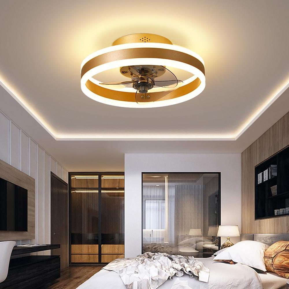 Gold ceiling fan with dual LED ring light mounted in contemporary bedroom.